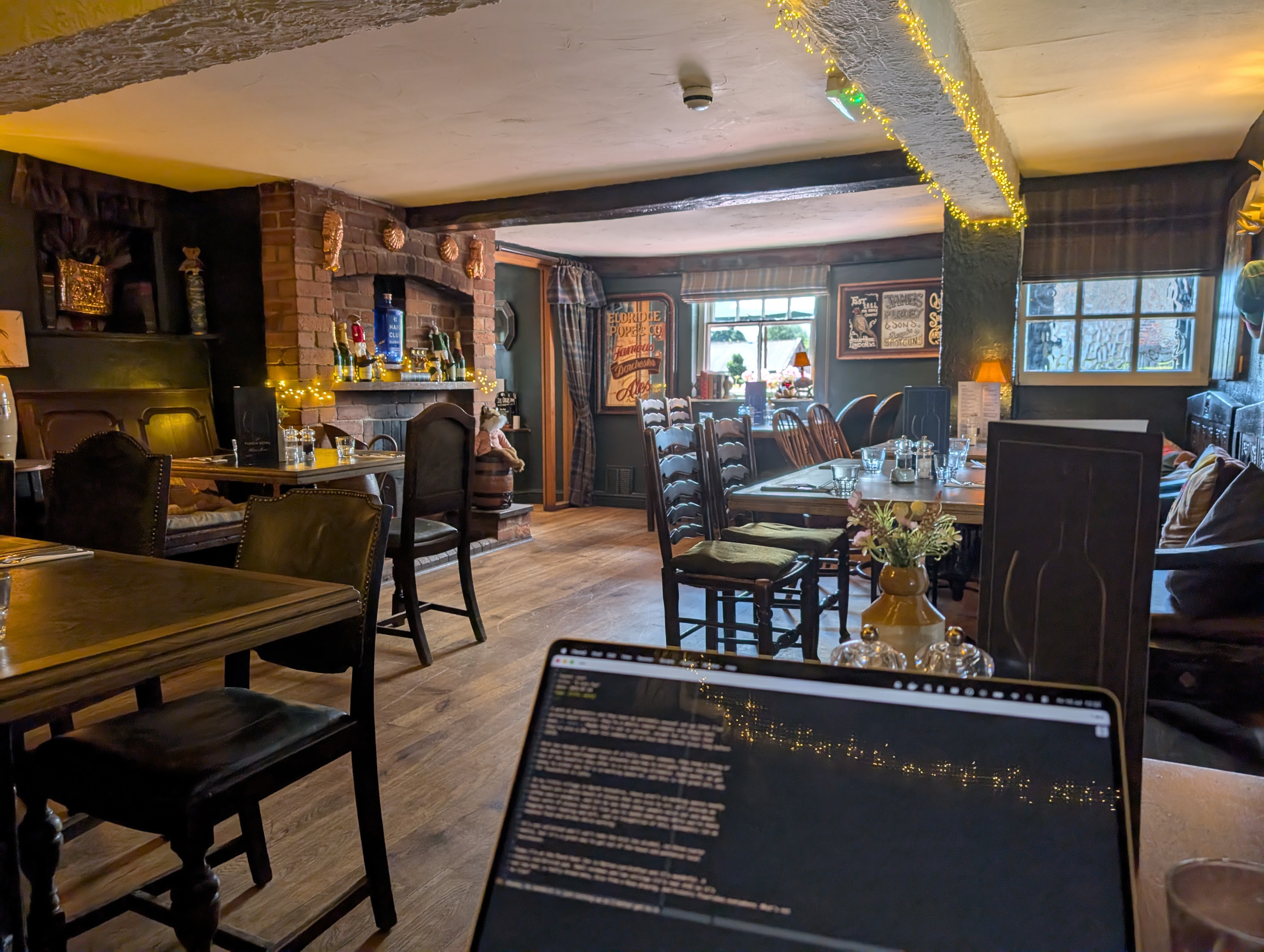 A laptop in front of a traditional British
pub